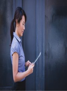 asian businesswoman looks at written document